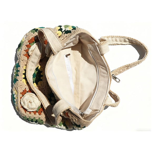 Handmade crochet bag with 3D flowers, open view showcasing vintage knitted tote interior.